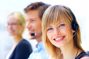 A woman wearing a headset and smiling.